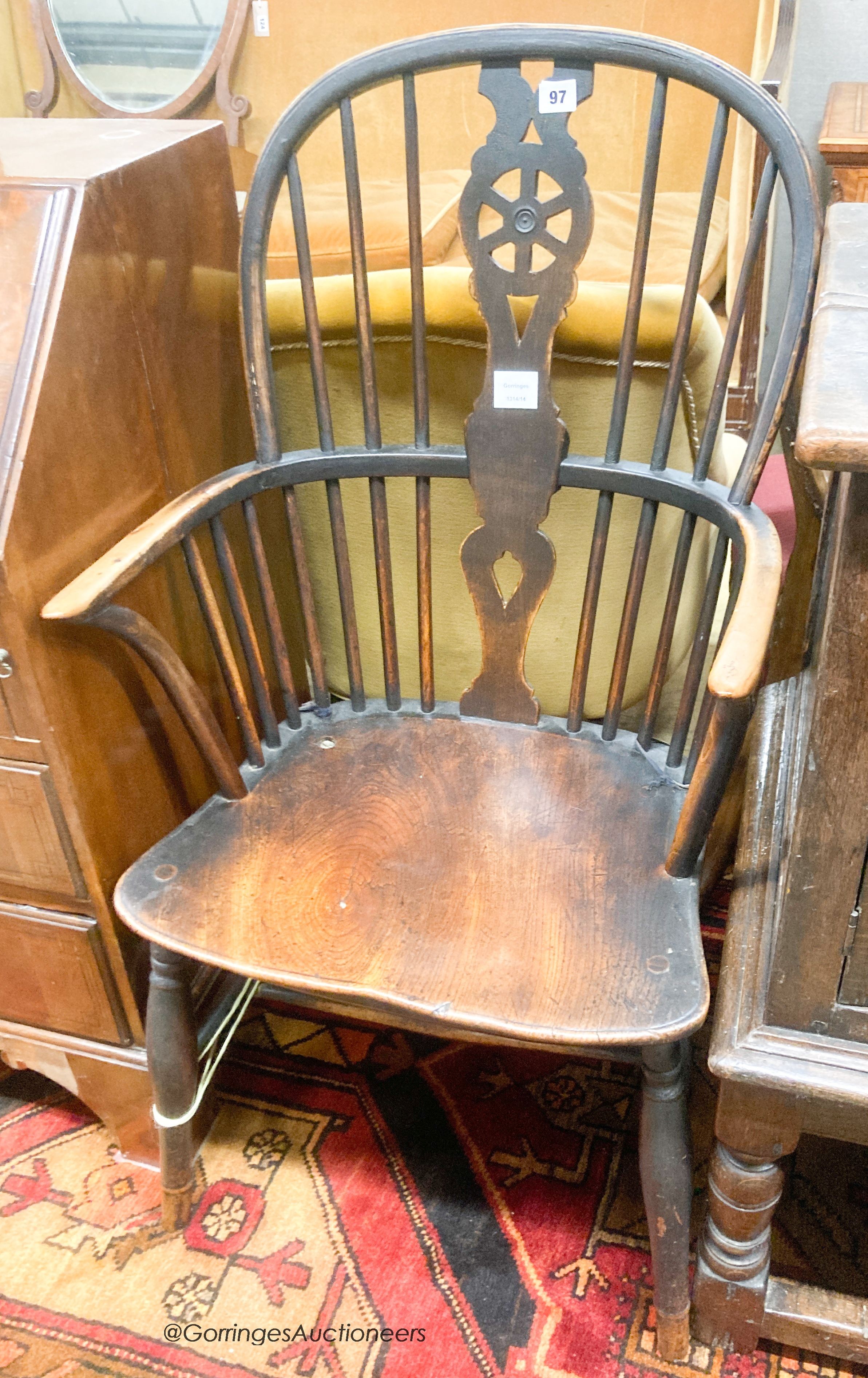 An early 19th century elm and ash wheel back elbow chair, width 52cm, depth 42cm, height 102cm